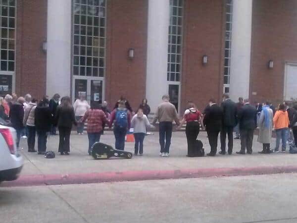 Student's and Alumni praying for Louisiana College in front of Guinn Auditorium