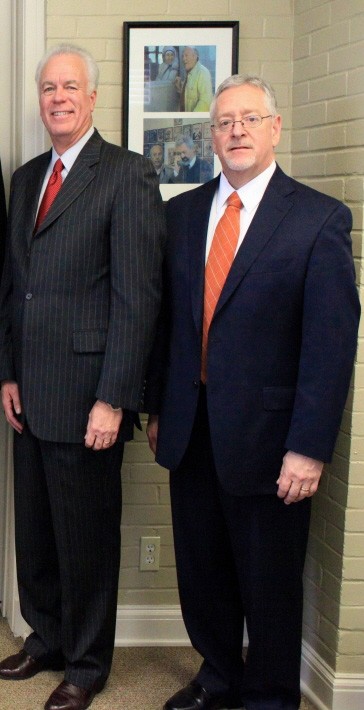 Joe Aguillard and David Hankins standing together in suits