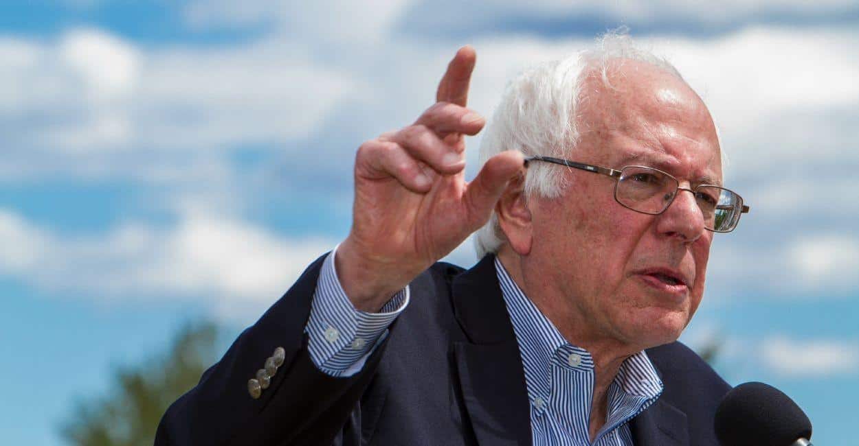 Bernie Sanders speaking with his hand up making a point