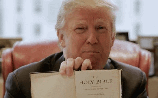 Donald Trump holding up an open Bible