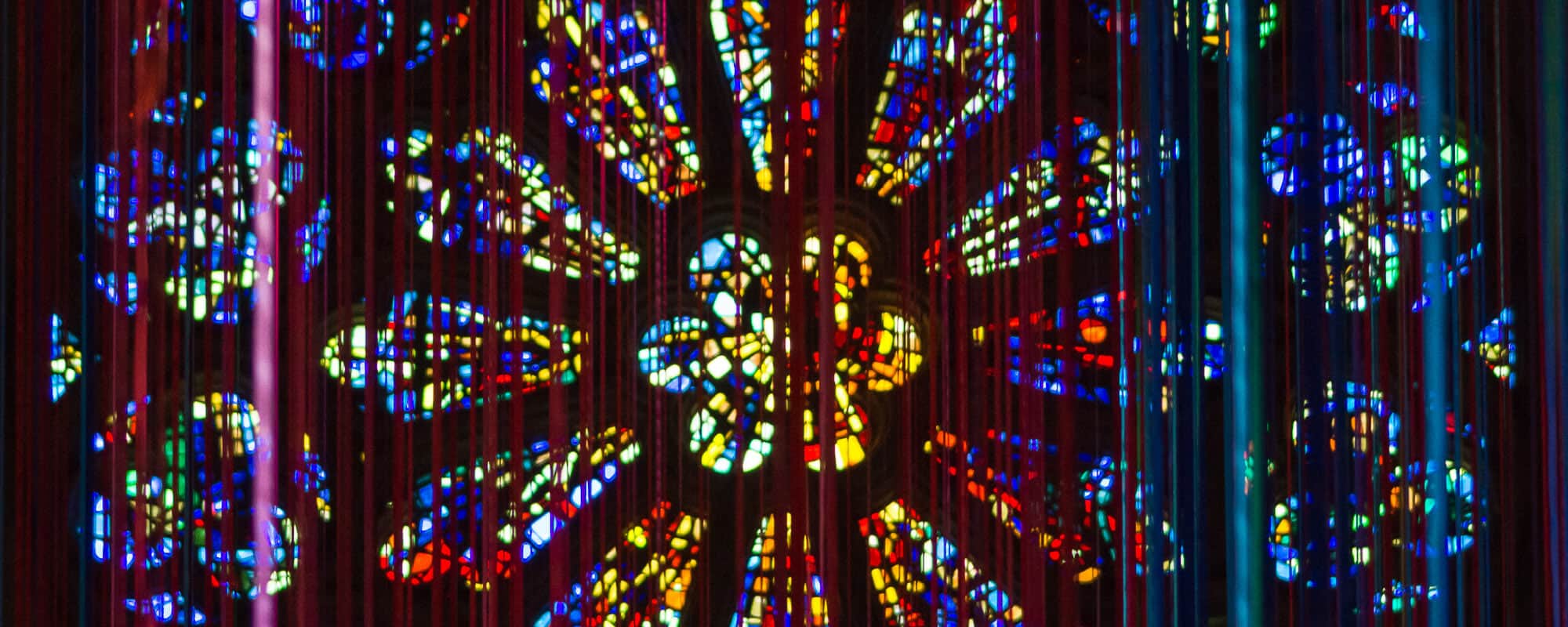 An art installation hanging in front of the Rose Window at Grace Cathedral in San Francisco.