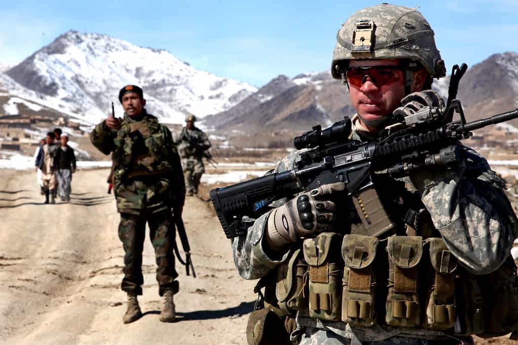 US troops in Afghanistan are shown in fatigues and with guns.