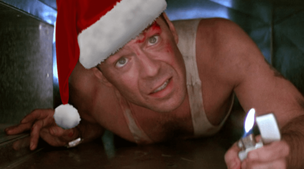 Bruce Willis is shown crawling in an air duct wearing a Santa hat in the movie Die Hard.