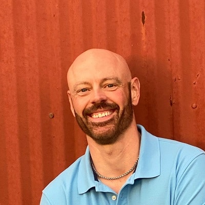 The author, Dan Ferren is shown in front of a wooden wall.