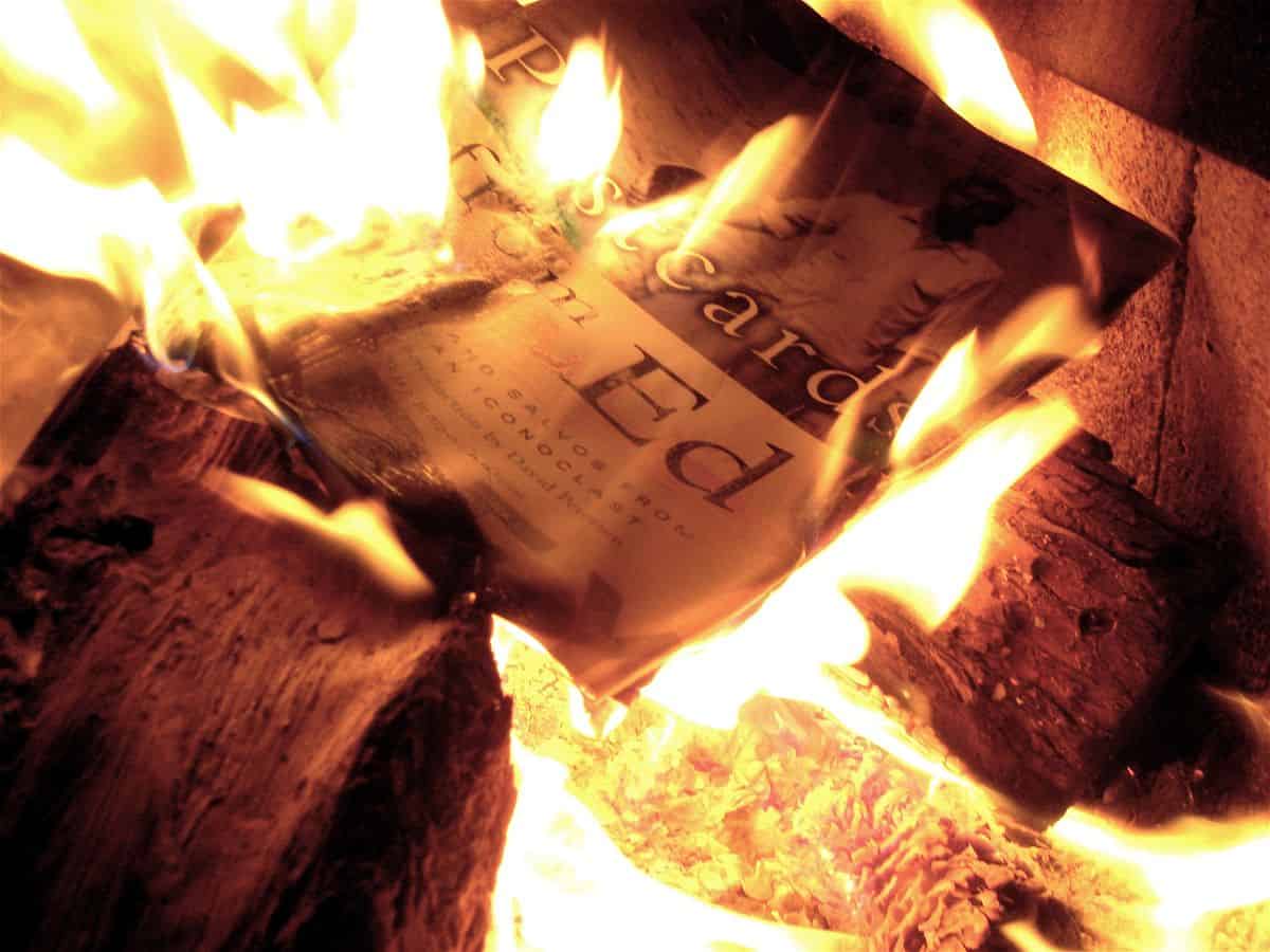 A book cover is seen on fire.
