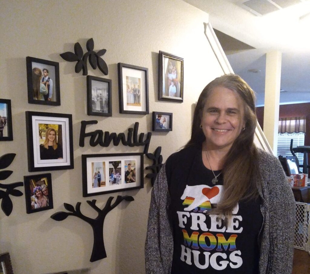 woman smiling wearing free mom hugs t-shirt