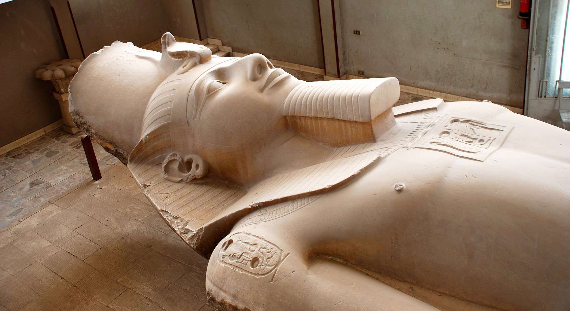 clay sculpture of an Egyptian pharaoh laying on its back