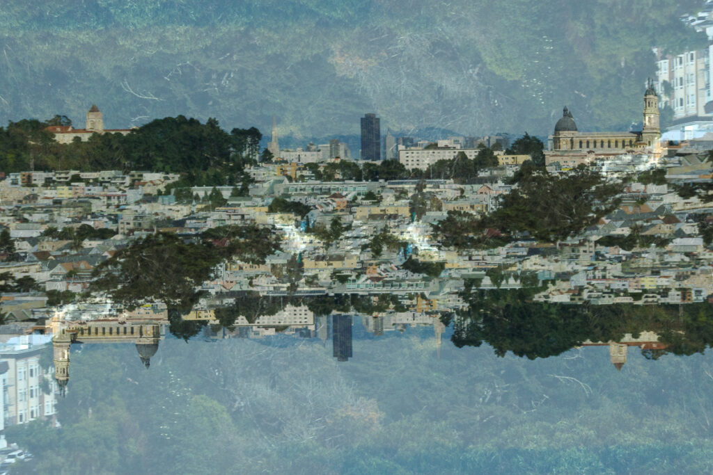 Image of a distant city skyline with a flipped version superimposed over it.