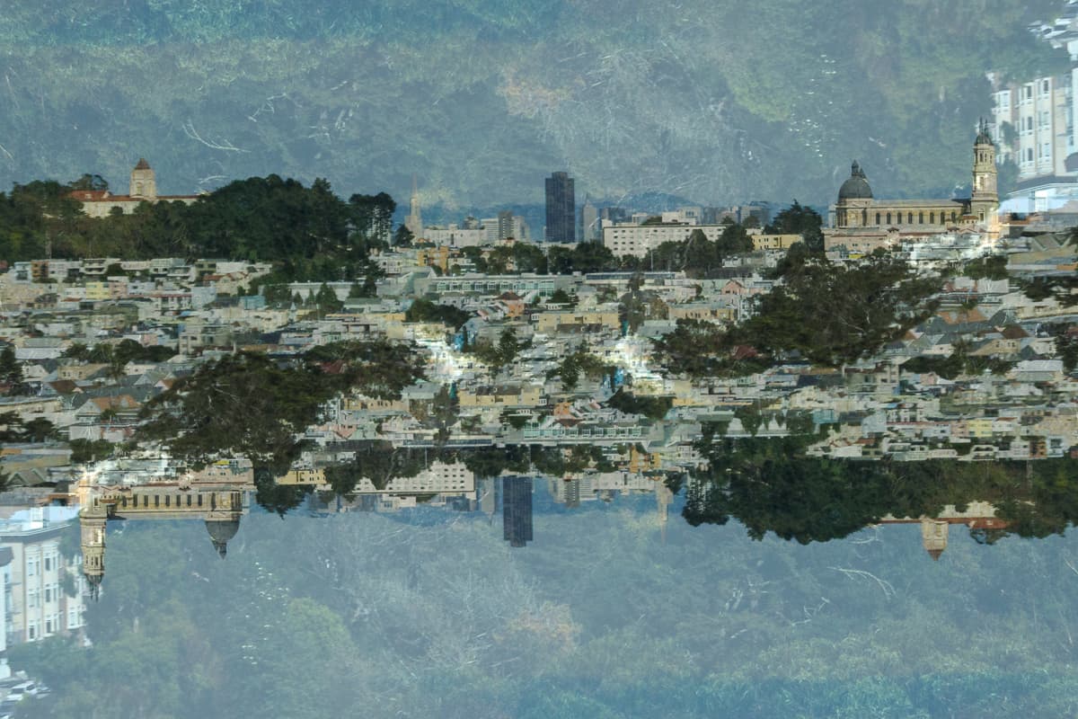 Image of a distant city skyline with a flipped version superimposed over it.