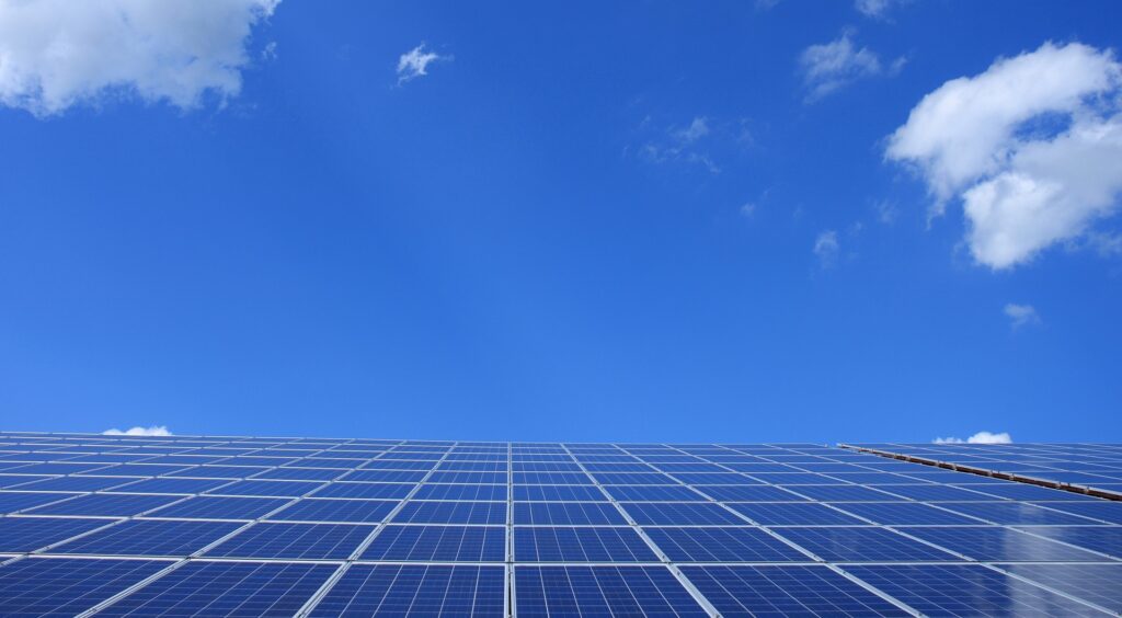 Solar energy panels with blue sky and some white clouds