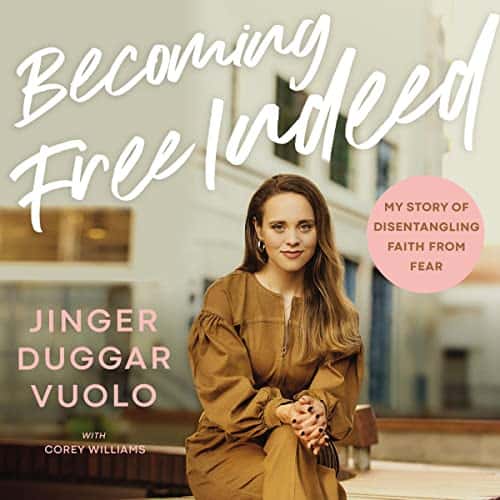 Jinger Duggar Vuolo sits in a brown pantsuit and smiles for this book cover photo.