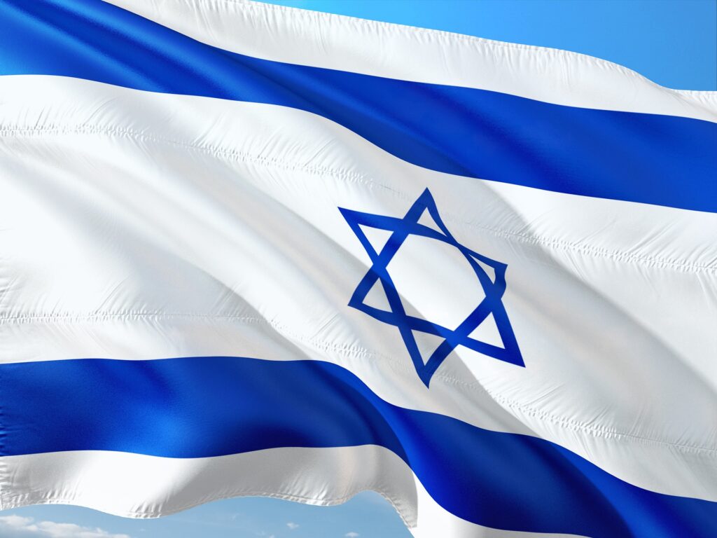 The flag of Israel waves in the wind.