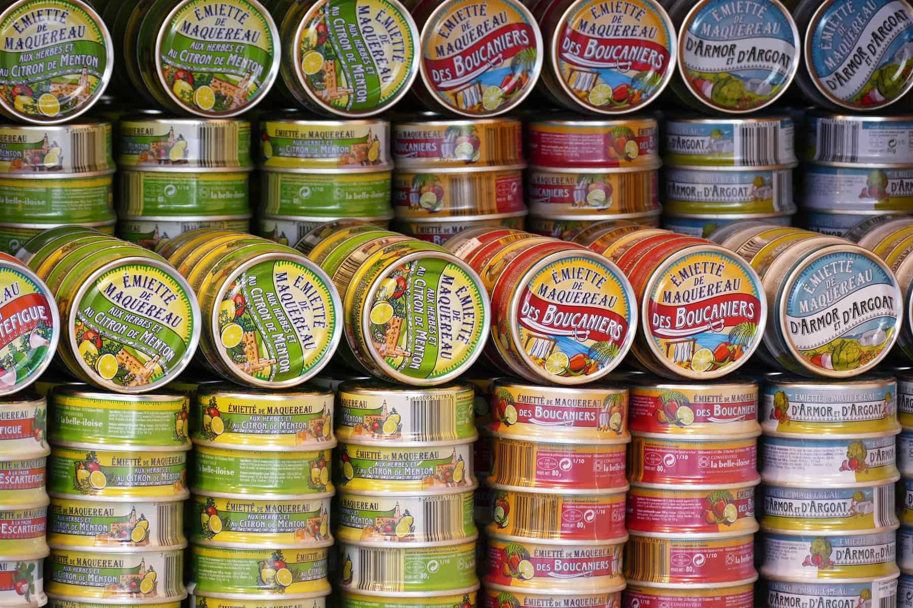 Stacks of colorful canned foods are shown.