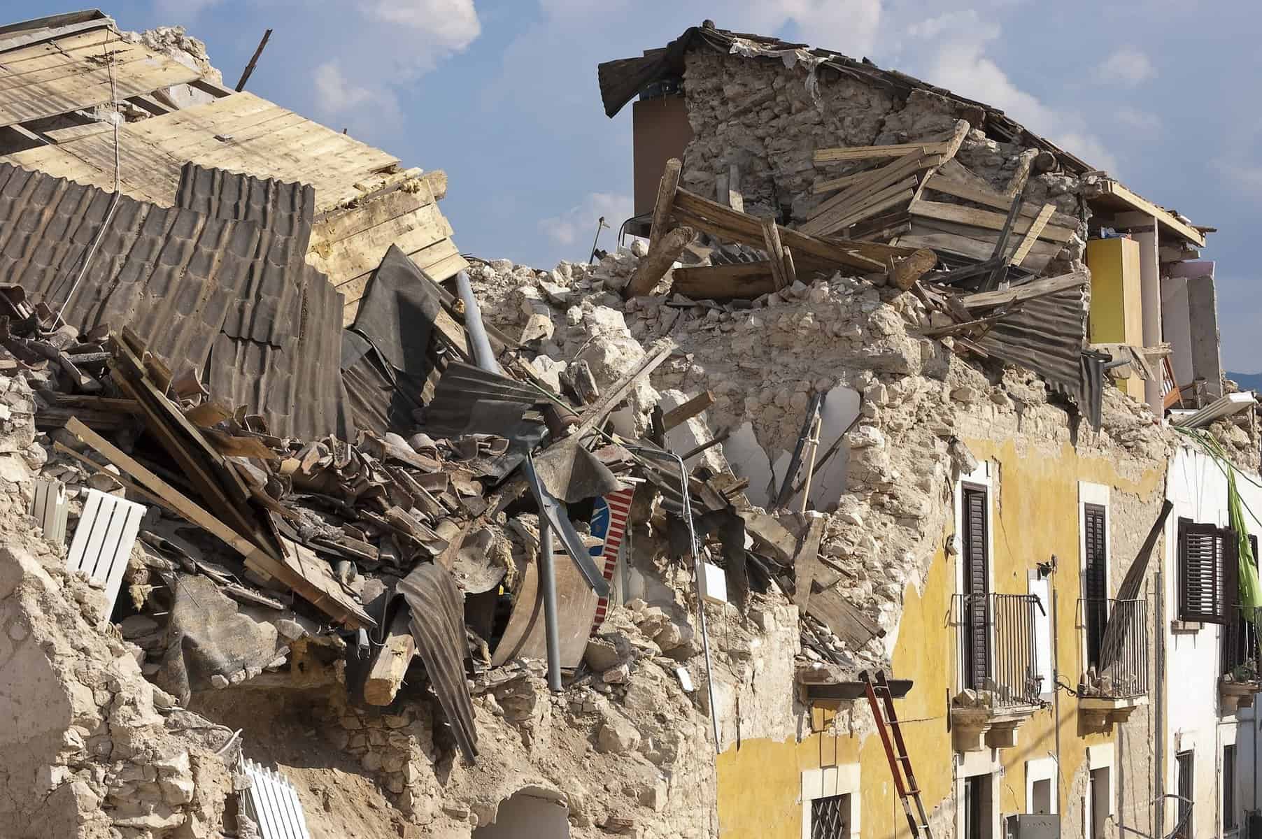 An earthquake destroyed stone building is shown.