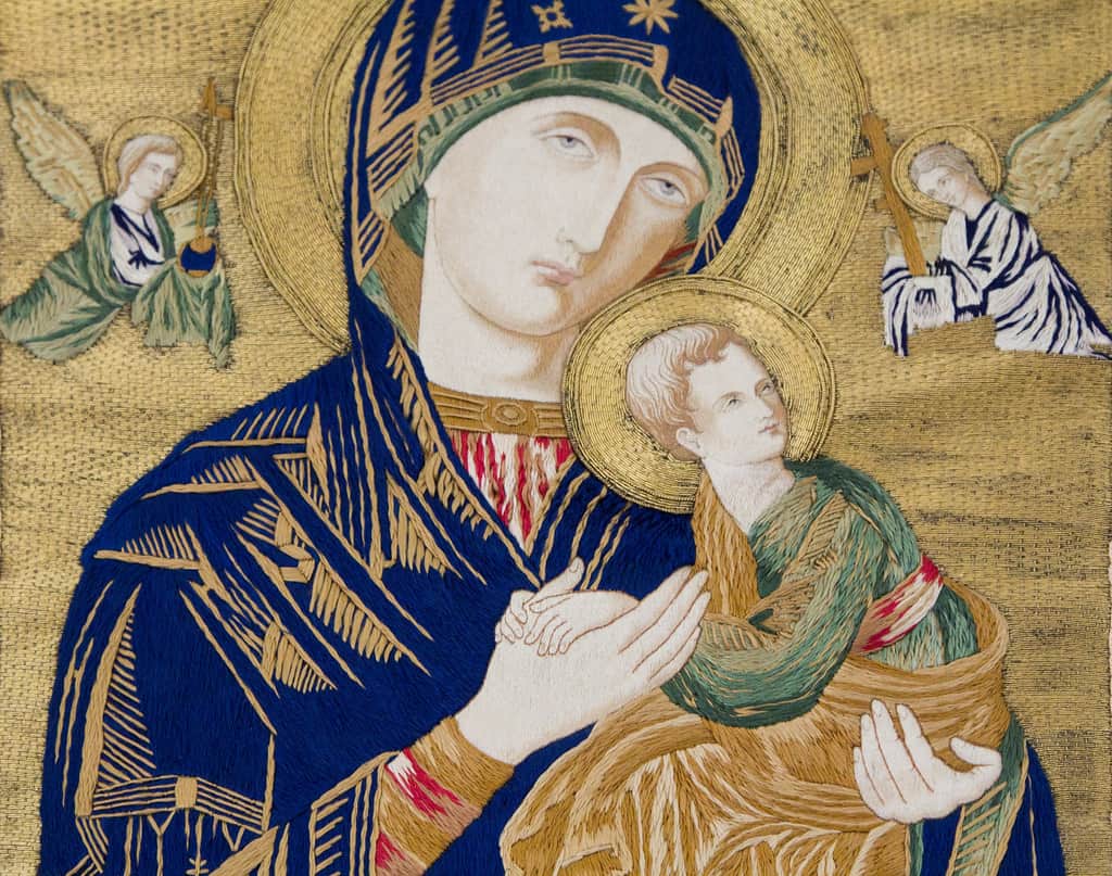 A richly painted icon is shown of Mary holding baby Jesus.