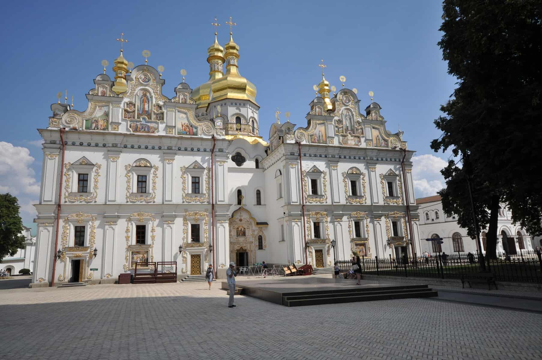The Cathedral of the Dormition is shown with its white stone and golden cupolas.