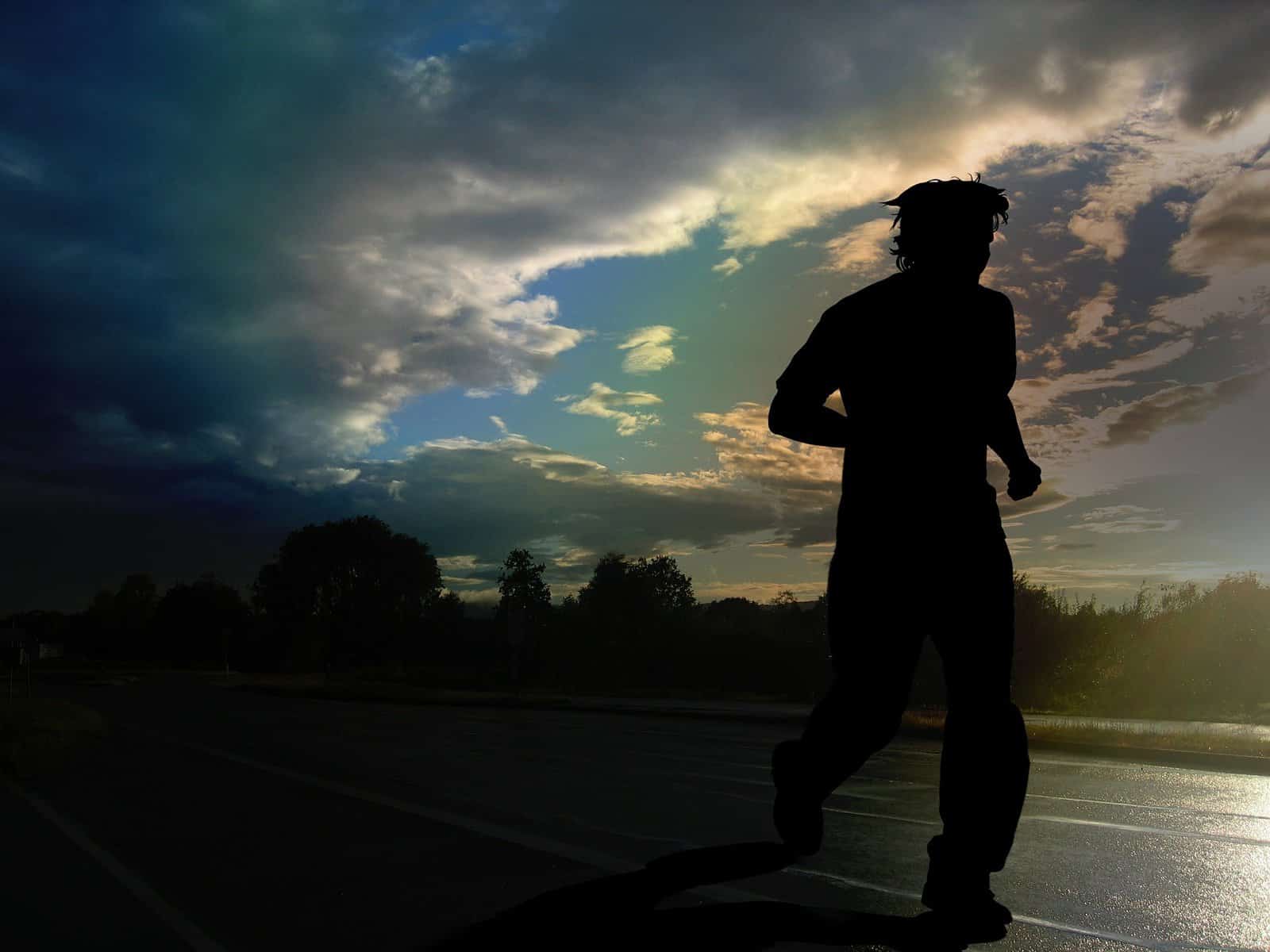 A person, possibly male, is shown in silhouette in a running posture.