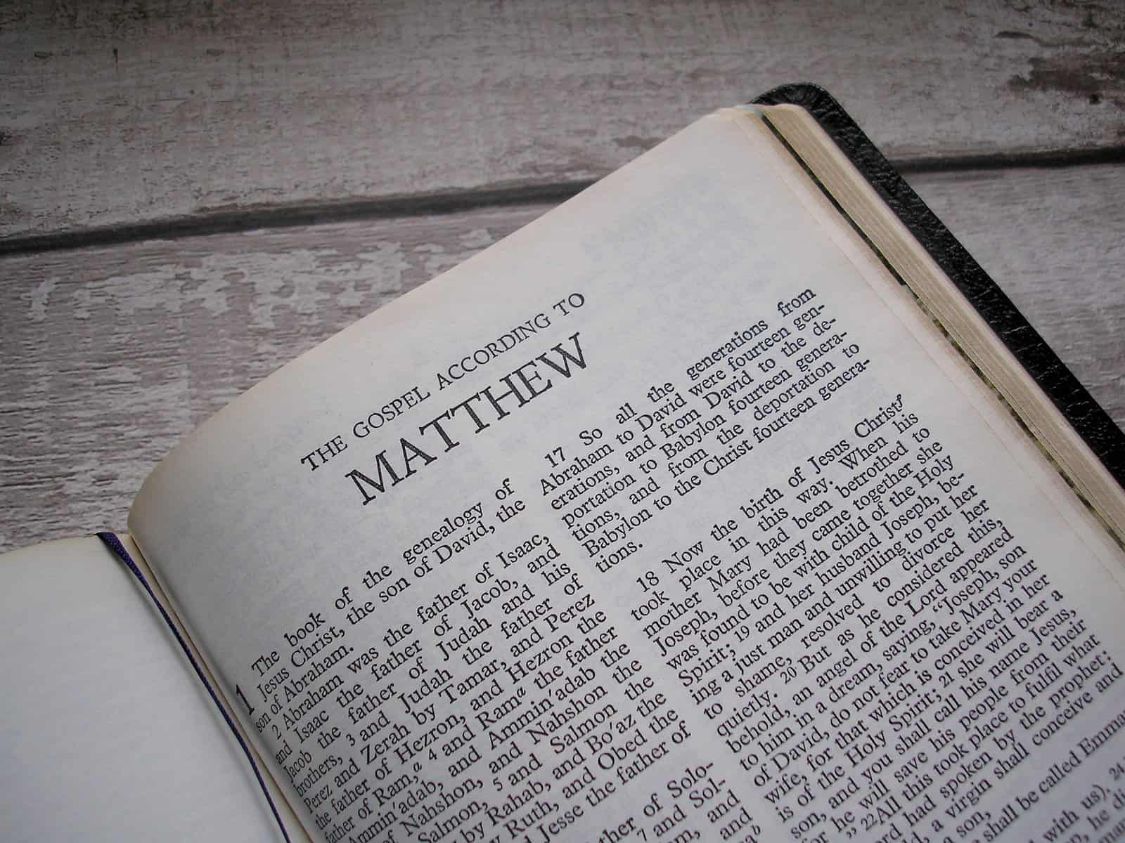 A bible is shown open to the first page of Matthew.