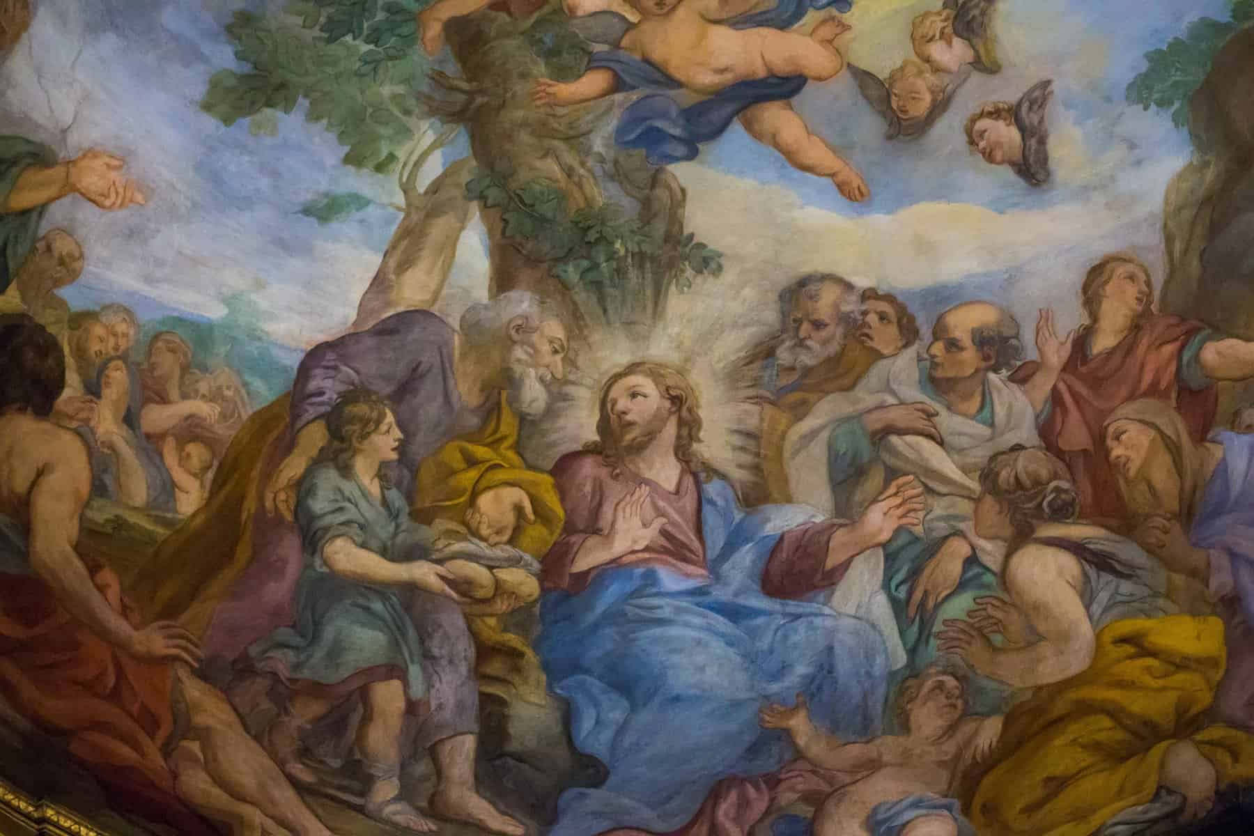 A painting depicts Jesus with angels above him.