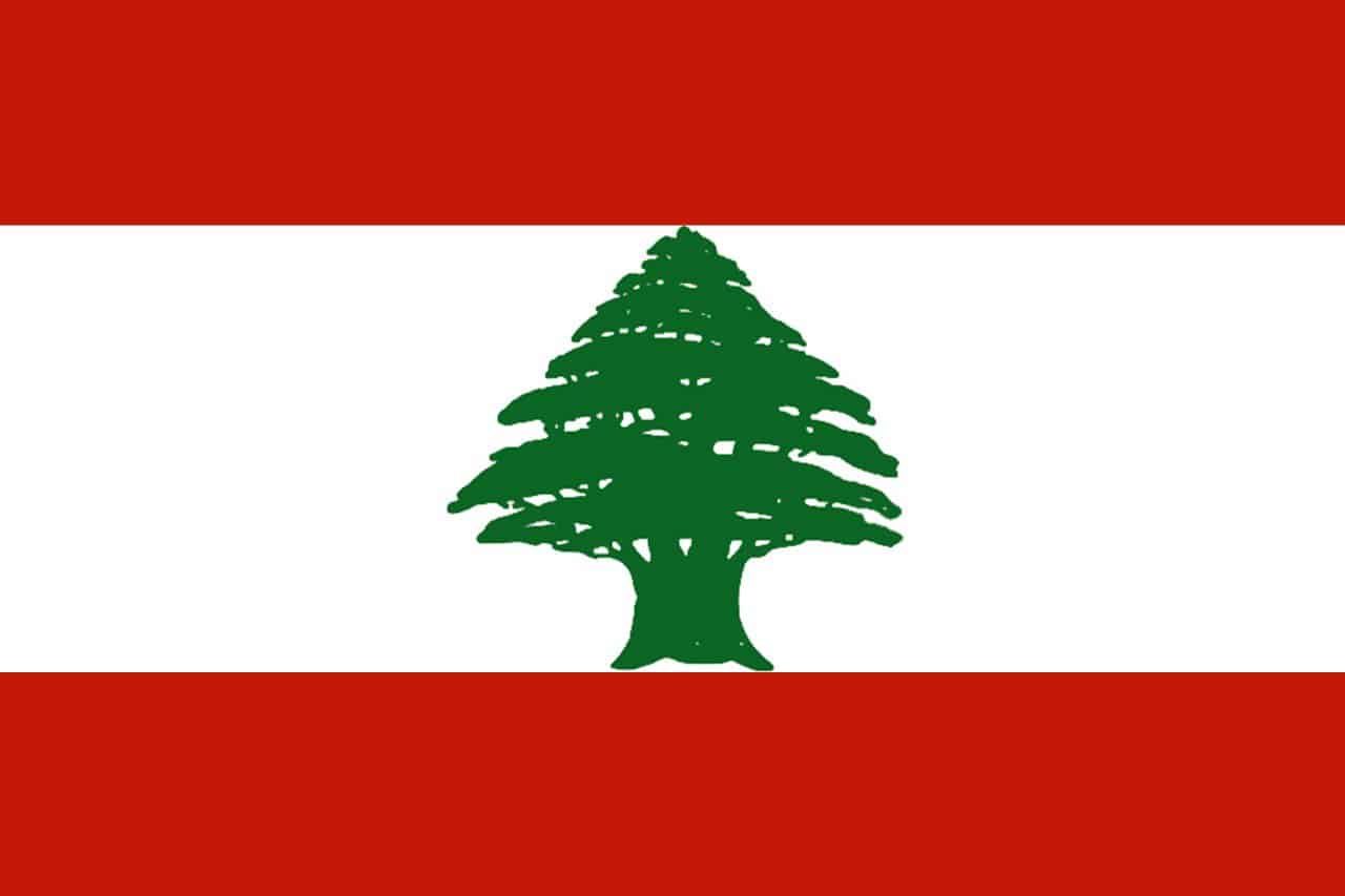 A digital depiction of the flag of Lebanon is shown with two white stripes bordering a white stripe with a green tree.