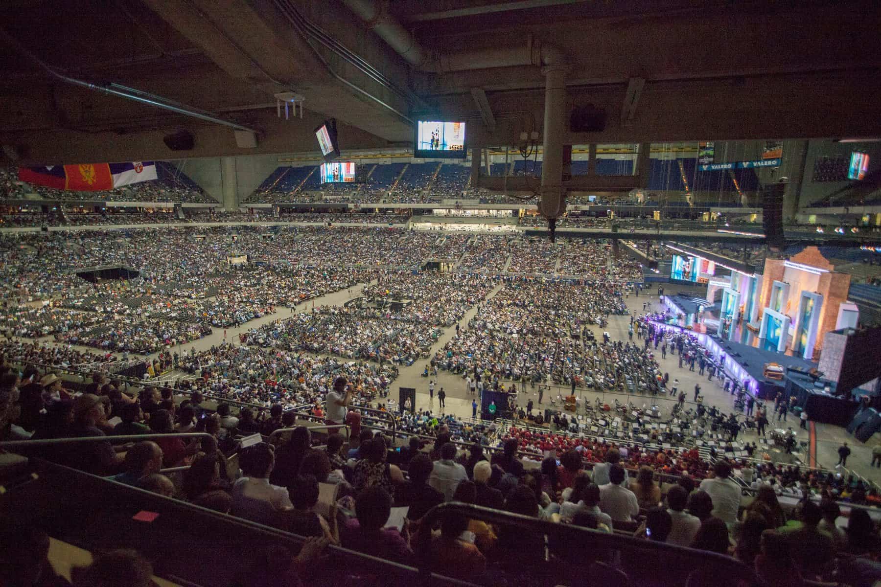 A huge crowd is seen inside a colosseum.