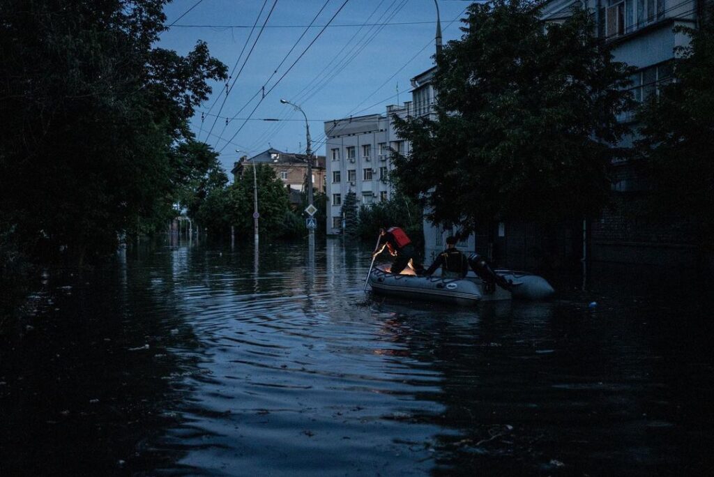 A deeply flooded street is seen in low light in Kherson.
