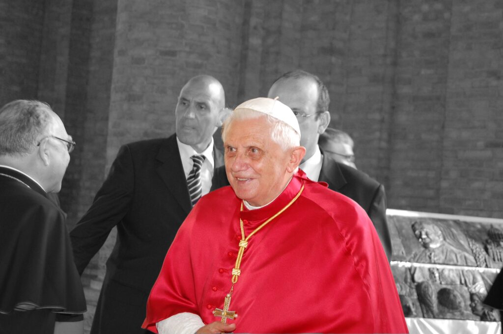 Pope Benedict is shown dressed in red.