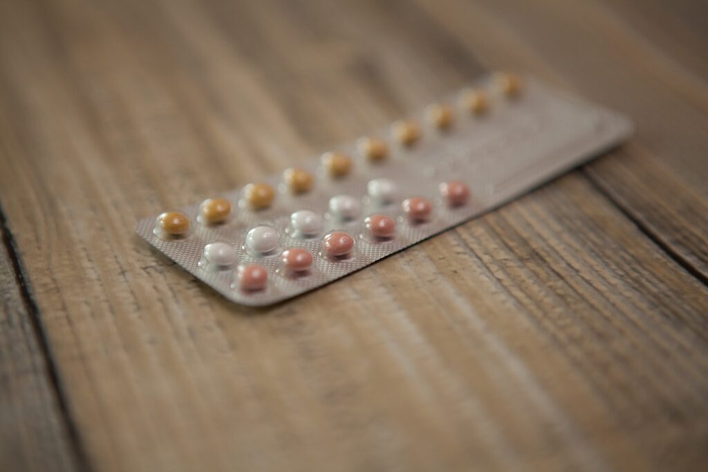 Three rows of brown and white pills in a blister pack is shown.