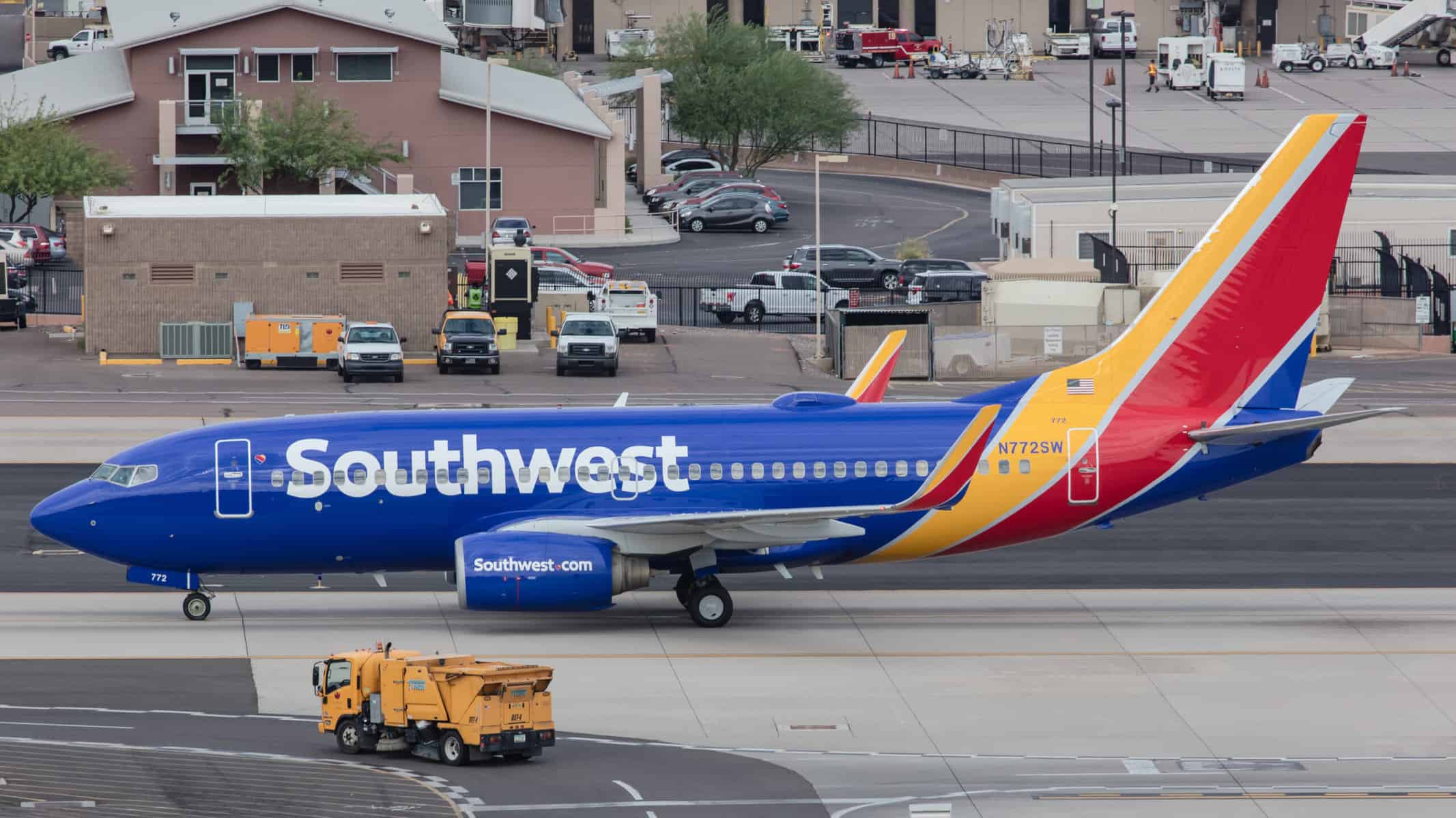 A brightly colored Southwest Airline plane is seen sitting at an airport.