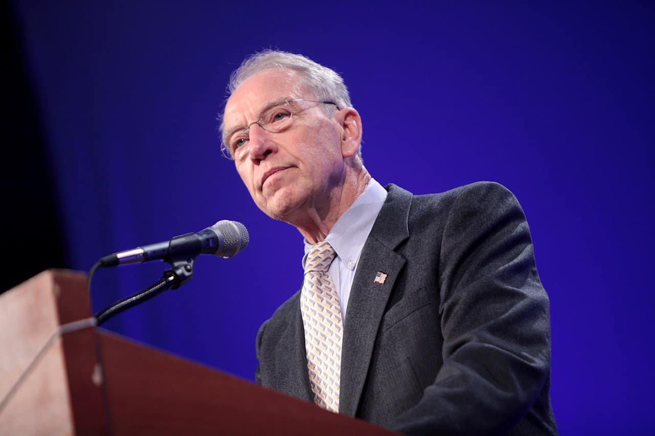 Senator Chuck Grassley stands at a podium with a microphone attached.