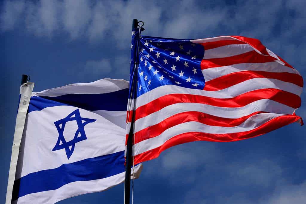The flags of Israel and the USA fly side by side.