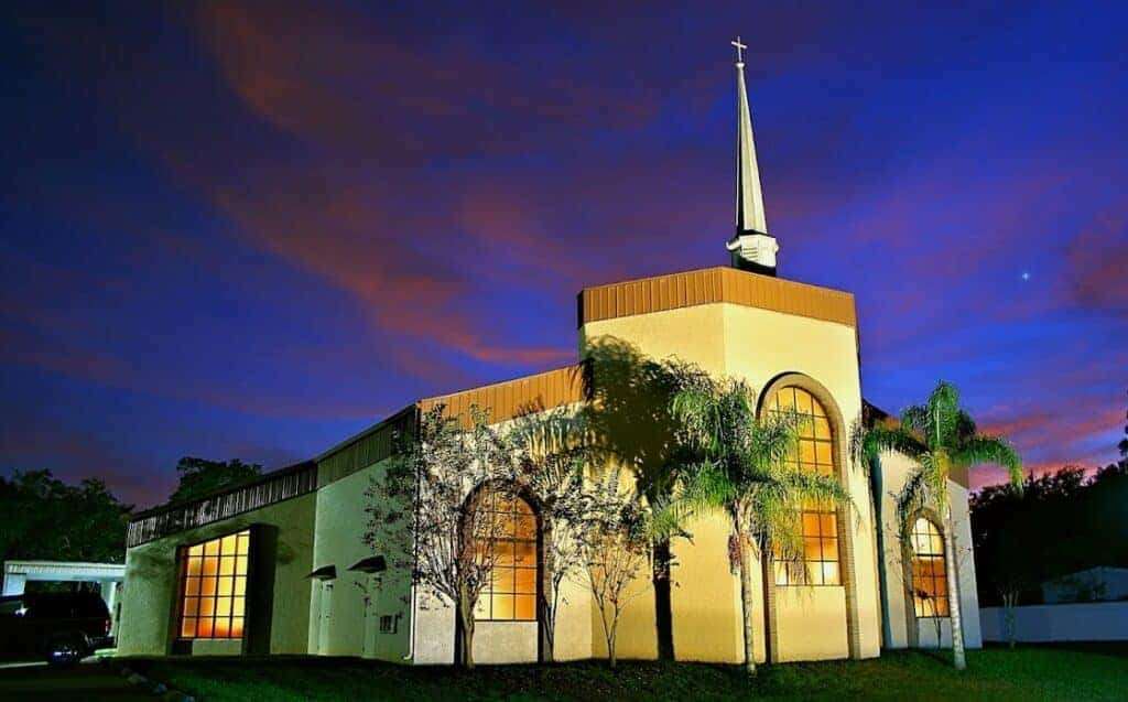 The church building of Pentecostals of Deland is shown during blue hour with pink clouds.