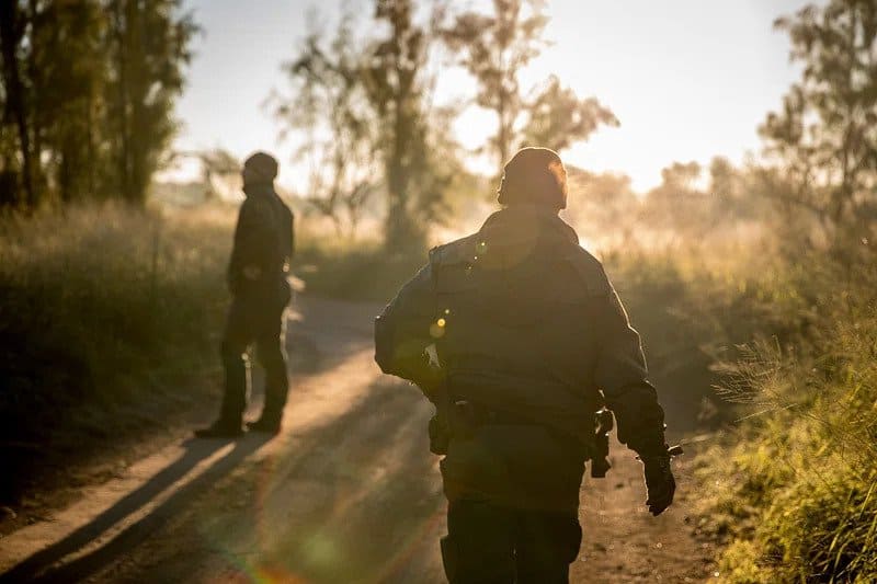 Two USA Border Patrol agents are shown in a hazy photo.