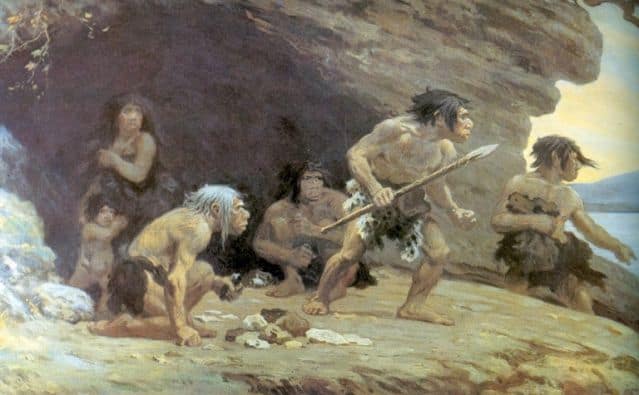 A caveman family, positioned just outside a cave, with father holding a spear is depicted in this painterly image.