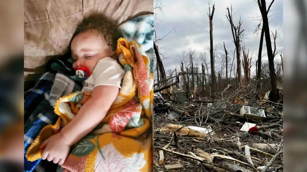 A baby with a cut on his forehead is shown wrapped in a blanket and sleeping. The other half of the photo shows trees stripped of leaves with debris laying around them.