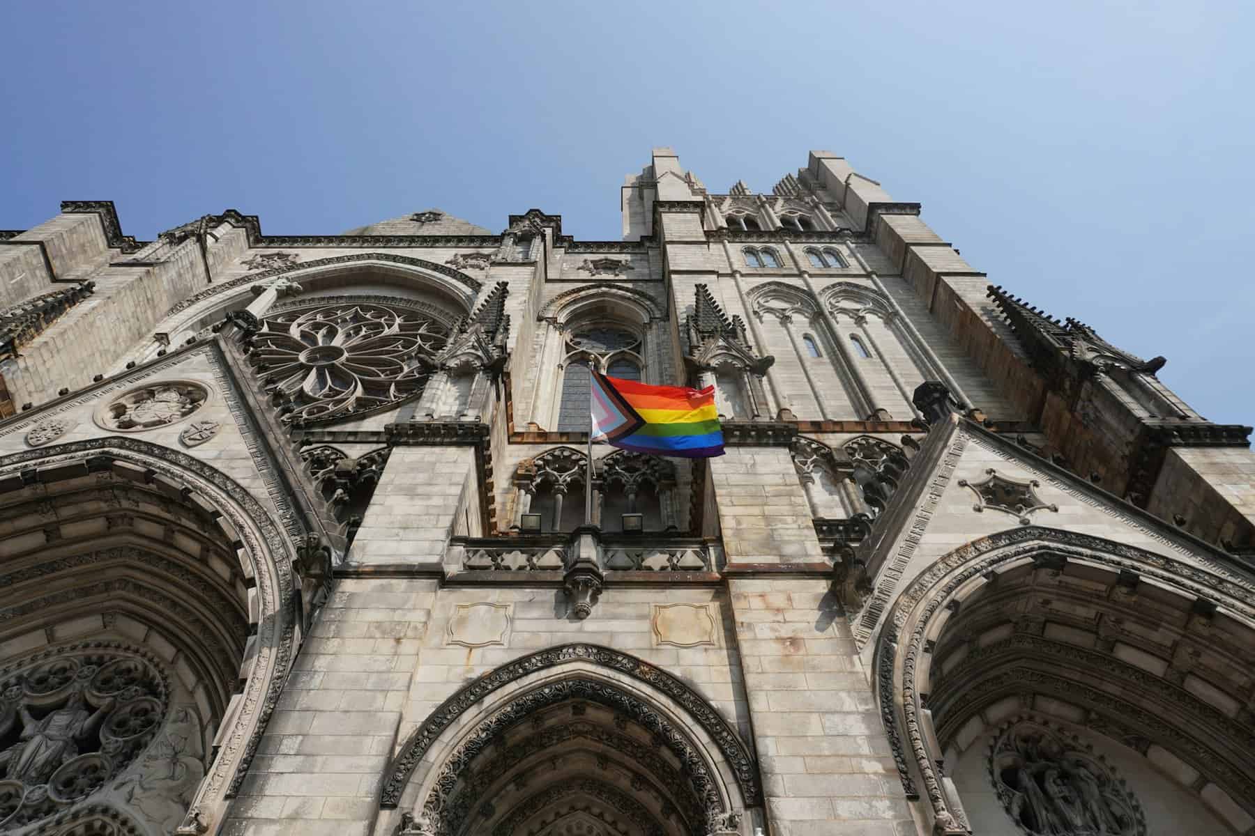 NYC Gothic church with a Pride flag in front.