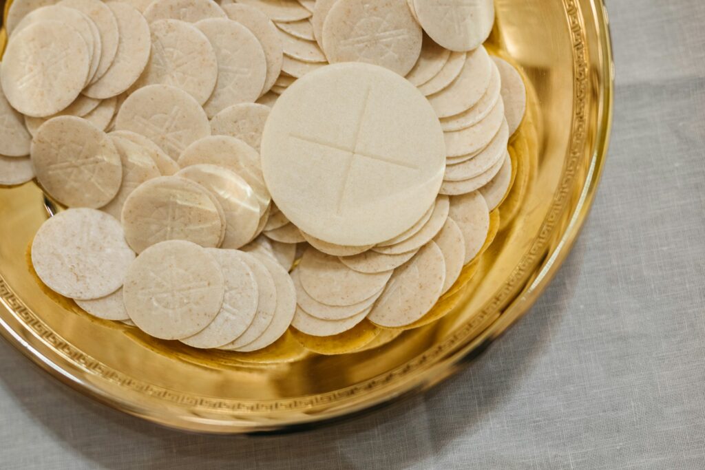 Fear of deportation drives immigrants away from churches under Trump Communion wafers in a gold plate