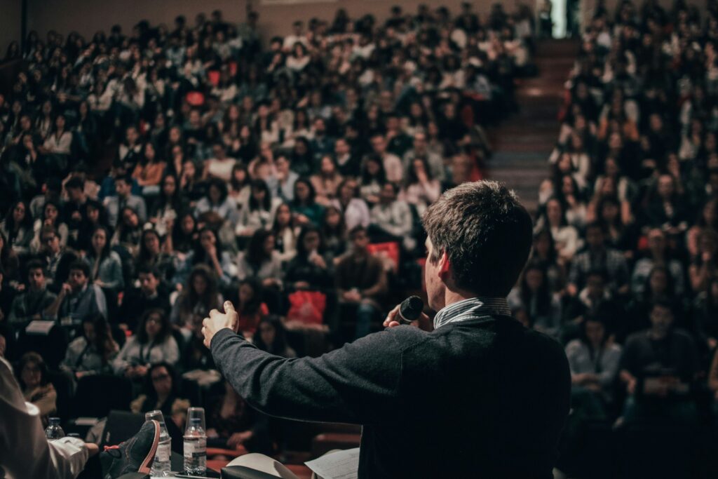 A young man speaking to an audience.