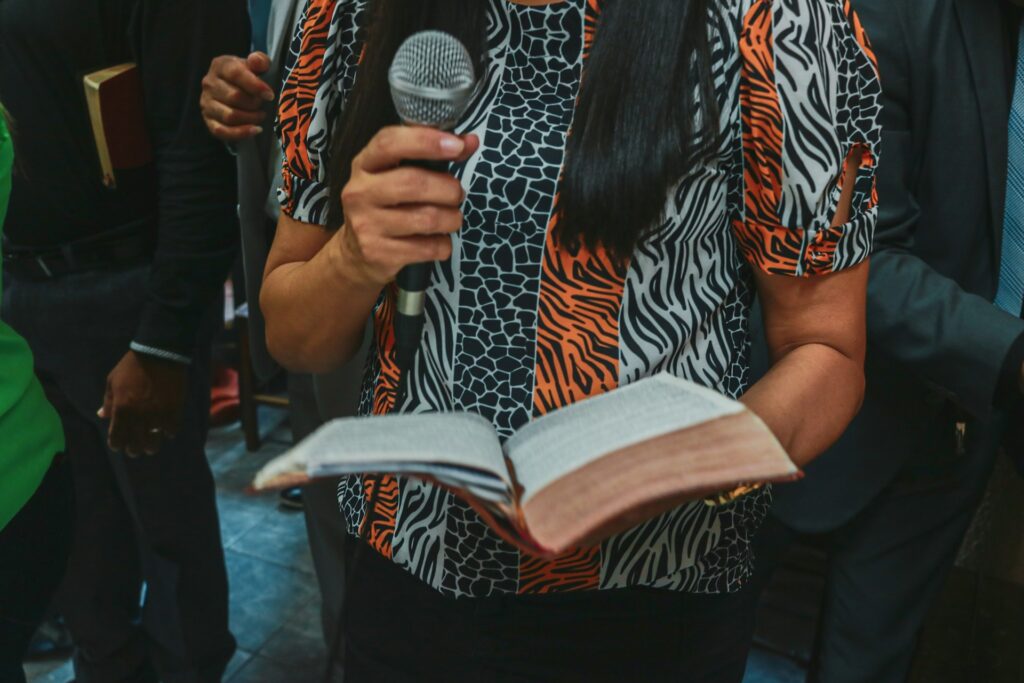 NBCUSA makes history with first female preacher at national meeting A woman holding a bible and microphone