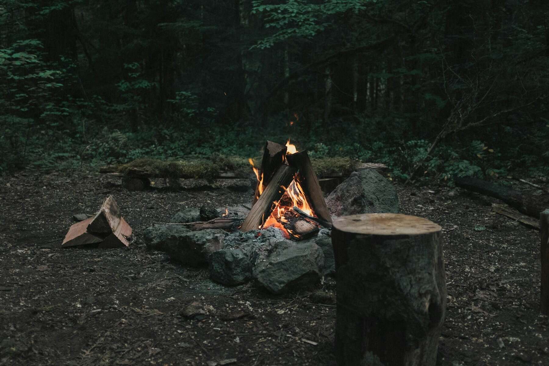 A campfire in a dark setting.