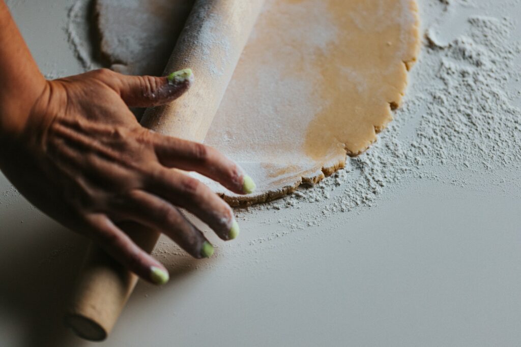 Rebuilding Hope: The women transformed by Oscar Amaechina’s Afri mission A woman rolling out a pie crust.