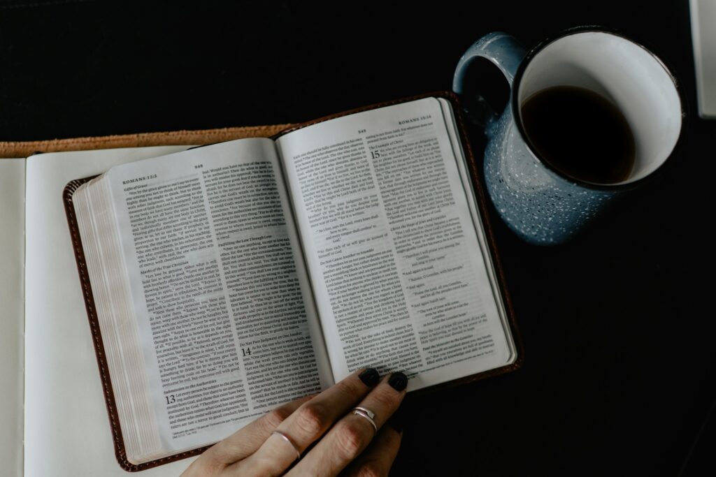 An open Bible with a cup of coffee next to it. Religion in America