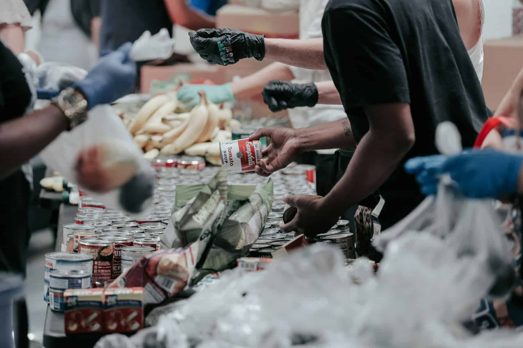 hands sorting canned goods