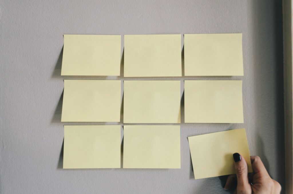 God Had a Different Plan: From Threat to Gospel Rows of yellow sticky notes with a hand removing one.