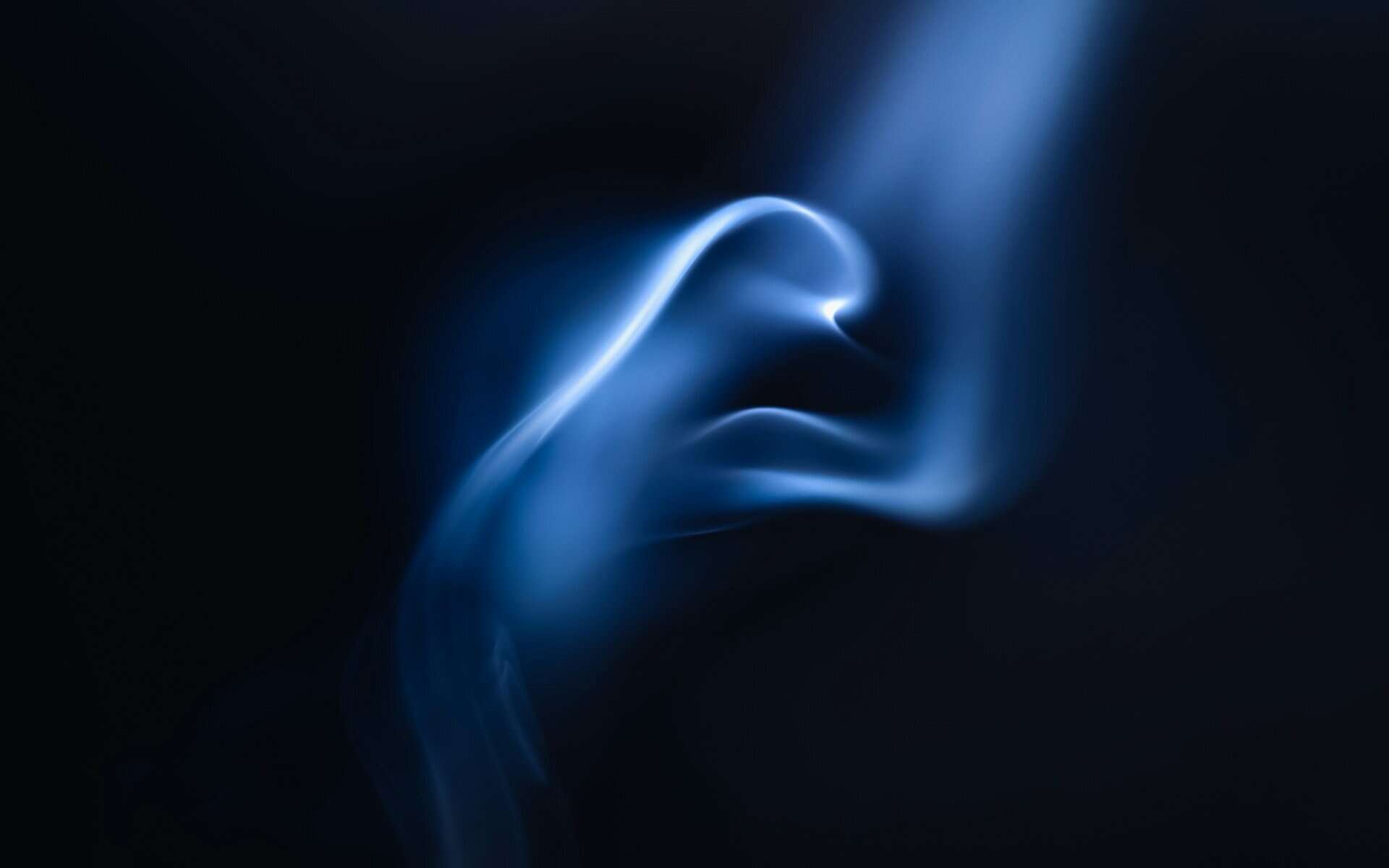 Bright blue smoke against a black background.