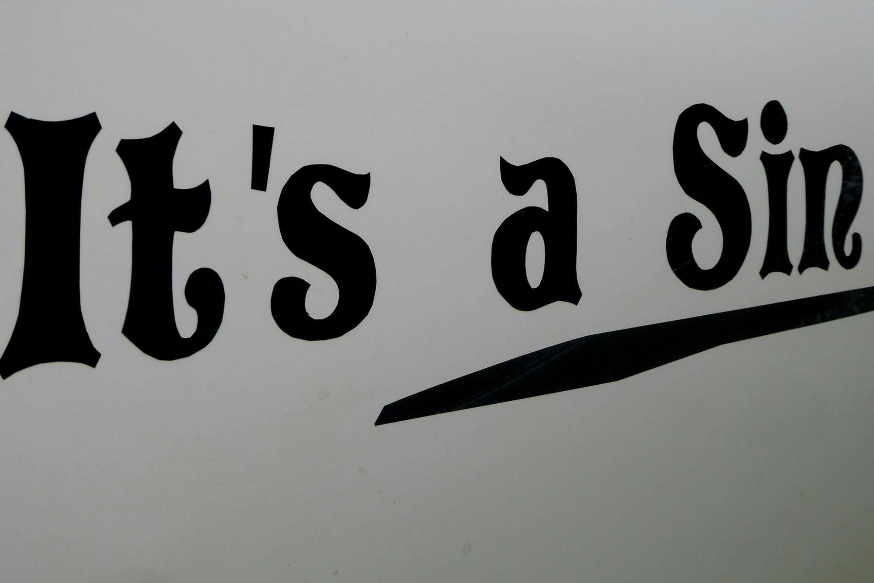 A sign with it's a sin written on it.