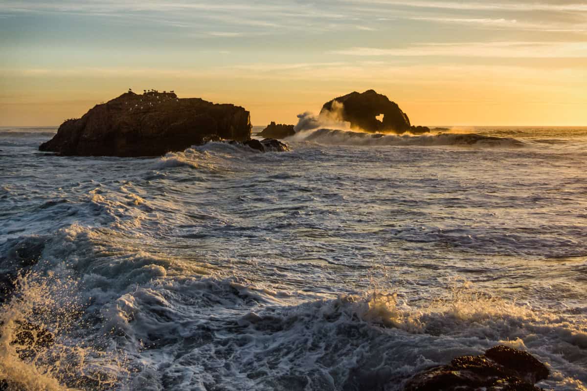 Waves at sunset crashing into the rocks at Sutro Baths near San Francisco.