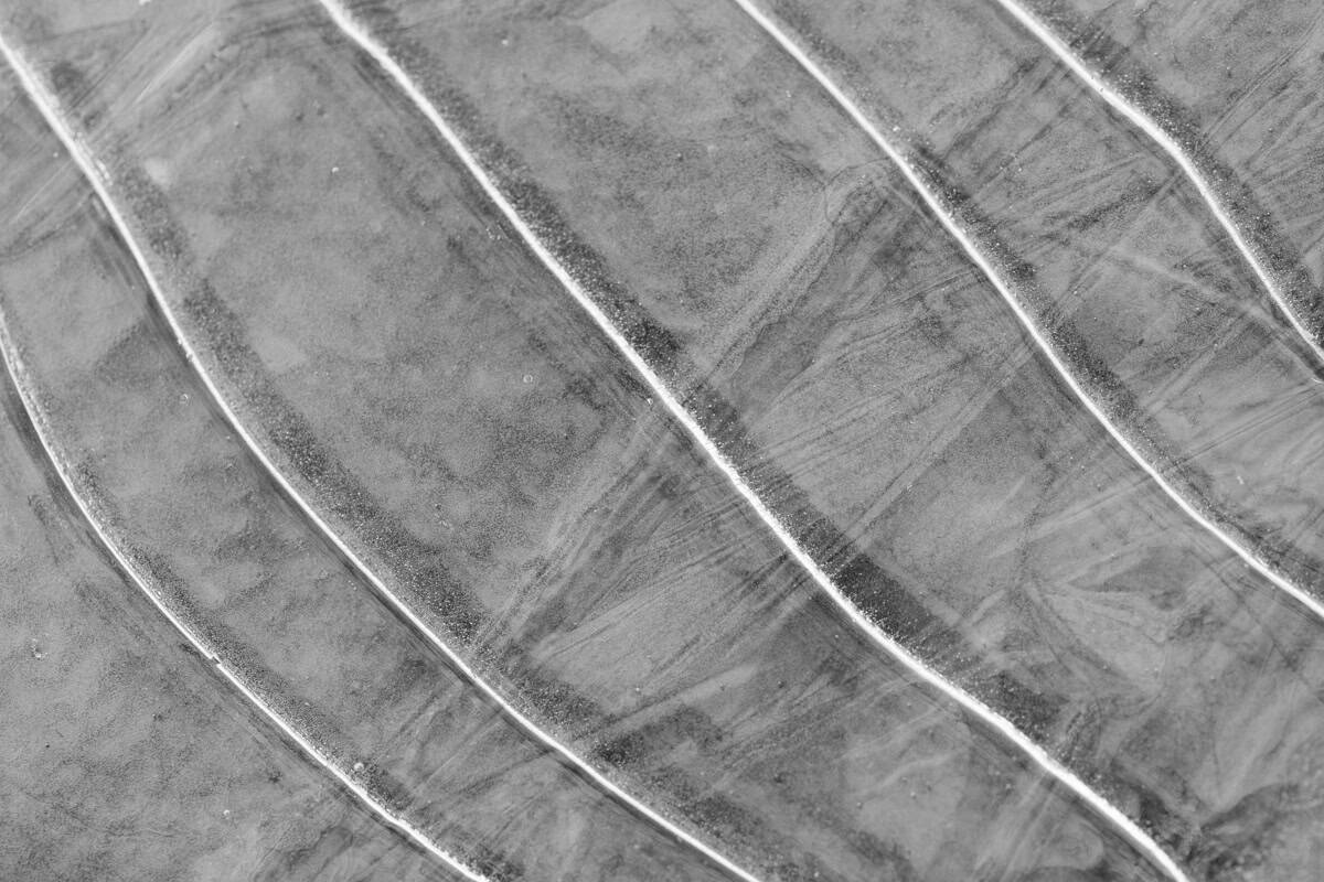 A black and white image of ice and it's textures.