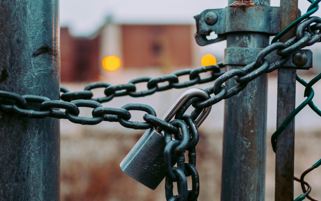 God’s Agent of the Autocratic State: Franklin Graham A chain and padlock on a chain link fence.