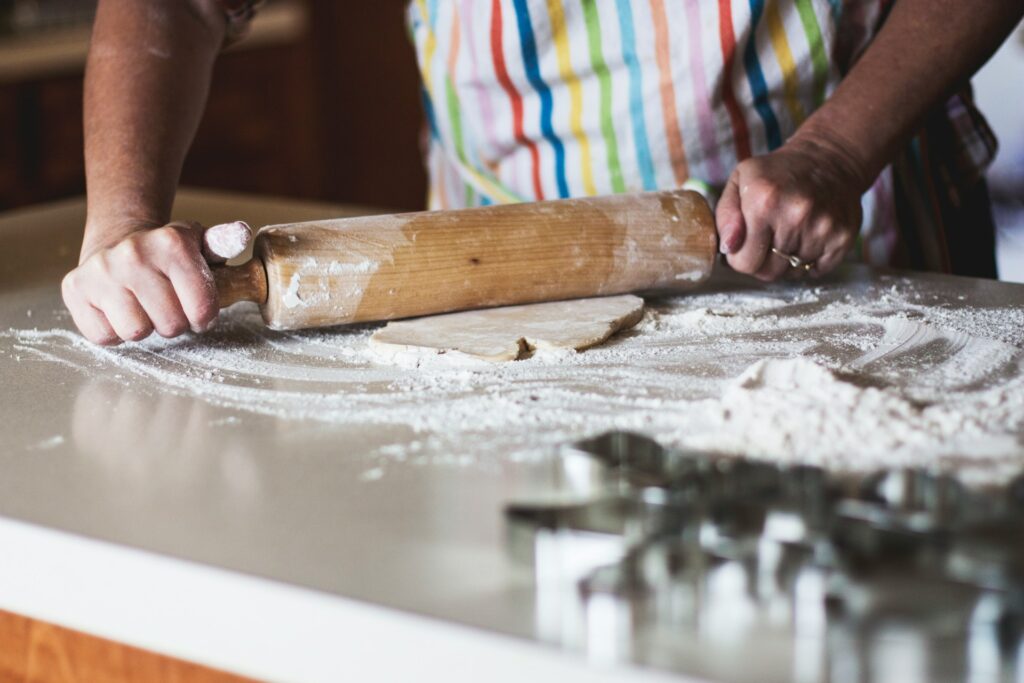Redemption Through Baking: Inside Cypress House Bakery’s new initiative A woman's torso and hands shown using a rolling pin in baking.